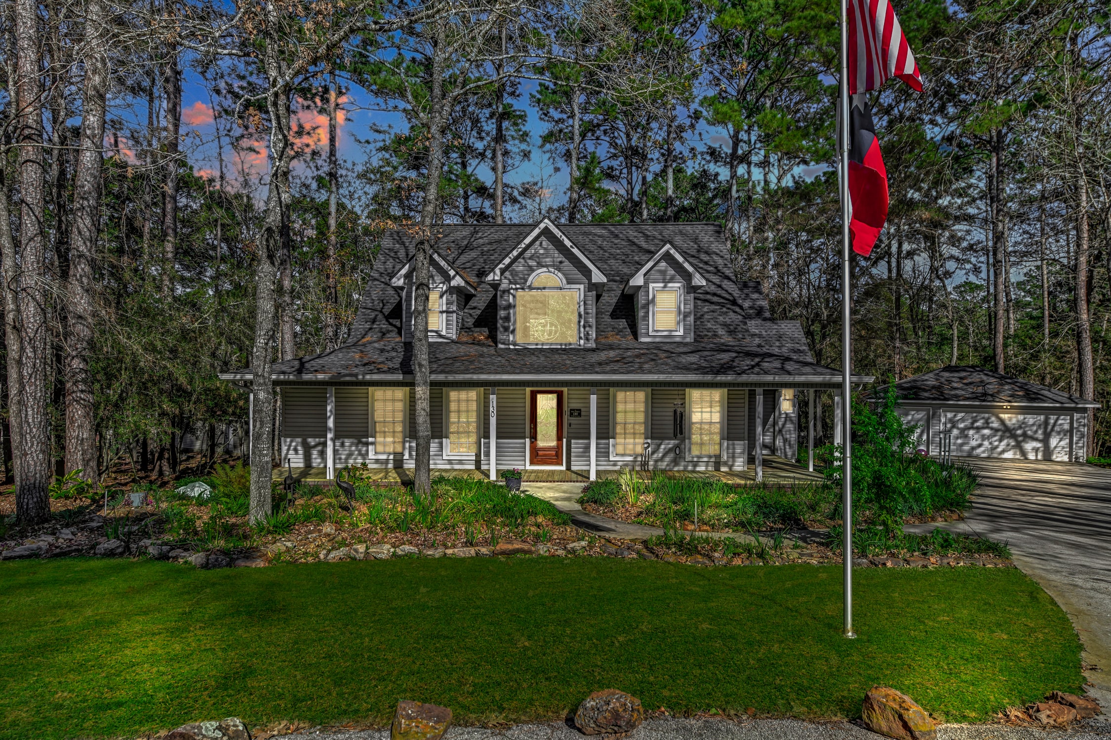 Twilight exterior of a wooded Texas home