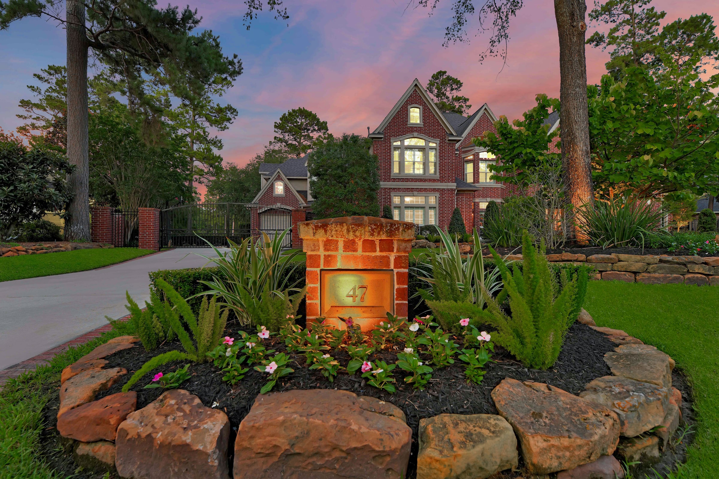 Twilight exterior of a red-brick estate