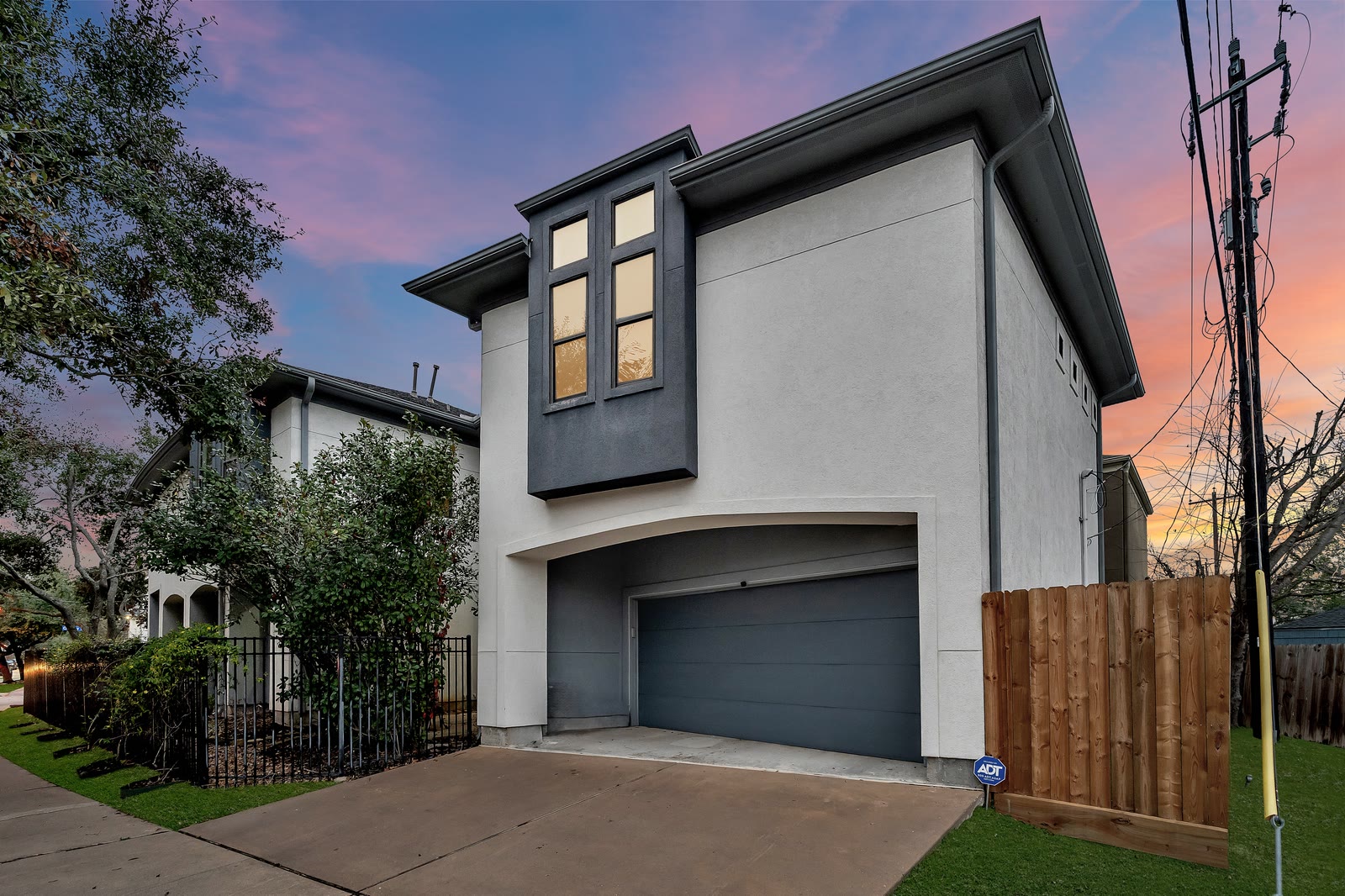 Modern townhome exterior at dusk
