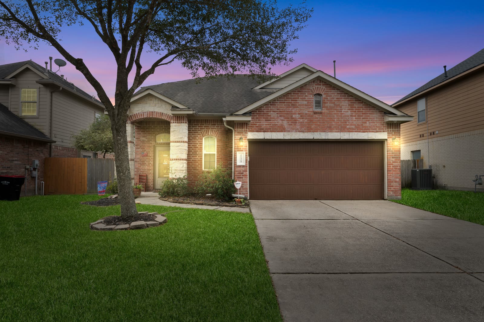 Brick home with exterior lights at twilight